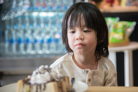 Cute Asian children eating honey toastの写真素材