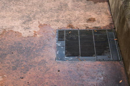 Close up of sewer manhole cover in a city streetの写真素材