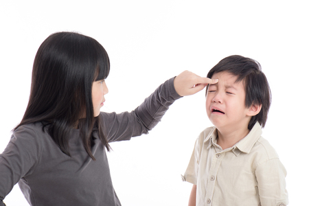 Asian sister and brother quarreling on white background isoatedの写真素材