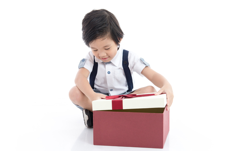 Cute Asian child opening gift present box on white background isolatedの写真素材