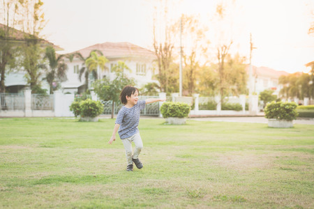 Cute Asian child playing pilot aviator in thee park outdoorsの写真素材