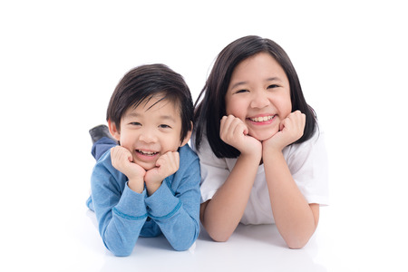 Cute Asian children lying on white background isolatedの写真素材