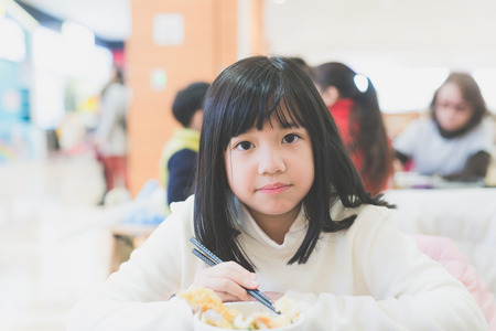 Beautiful Asian girl eating Tempura Rice Bowlの写真素材