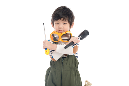 Cute Asian child with construction tools on white background isolatedの写真素材