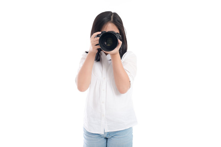 Cute asian girl holding  camera on white background isolatedの写真素材