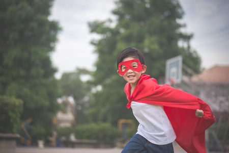 Asian child in in Superhero's costume playing in the parkの写真素材