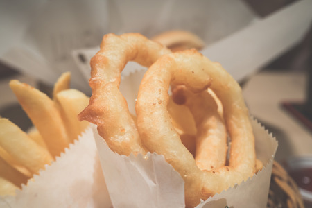 Close up of onion rings in paper bagの写真素材