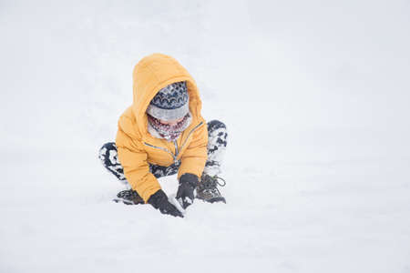 Happy Asian child playing in snowの写真素材