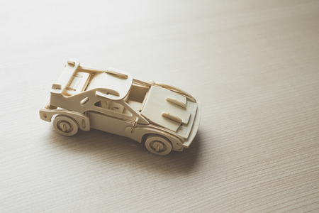 Wooden toy car on wooden floorの写真素材
