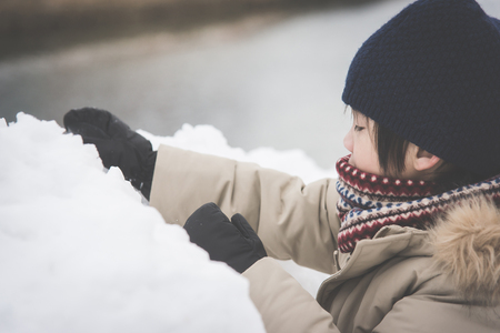 Happy Asian child playing in snow