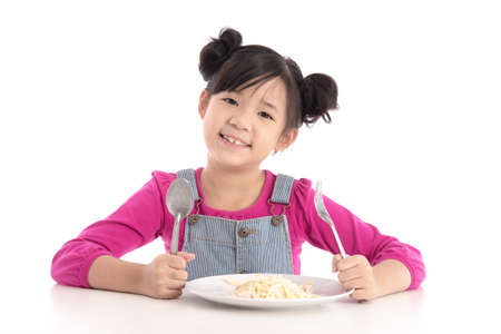 Cute asian girl eating Spaghetti Carbonara on white background isolatedの写真素材