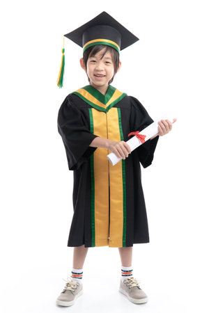 Happy Asian child in graduation gowns holding a Certificate on white background isolated.Graduation conceptの写真素材
