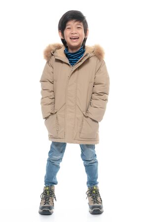 Cute Asian boy in warm clothing on white background. isolatedの写真素材