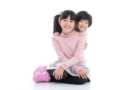 Cute asian children sitting on white background isolatedの写真素材