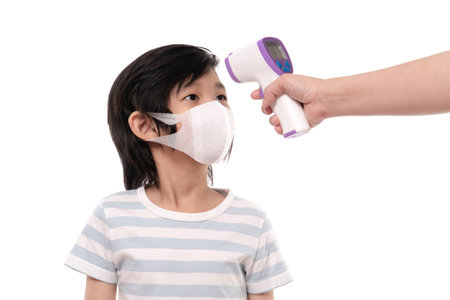 Asian child with protection mask with infared thermometer  on white background isolatedの写真素材