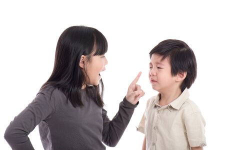 Asian sister and brother quarreling on white background isoatedの写真素材