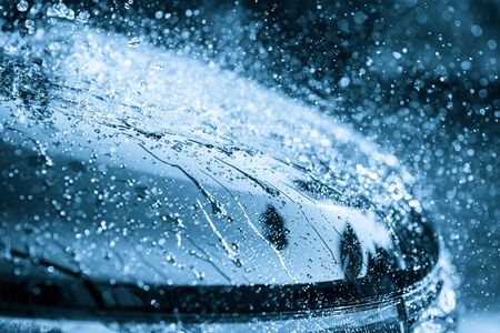 Splash of water on the black carの写真素材