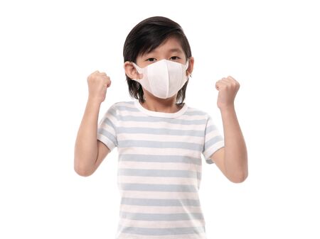 Cute Asian child with protection maskshowing winner sign on white background isolatedの写真素材