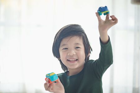 Cute asian child playing toy carsの写真素材