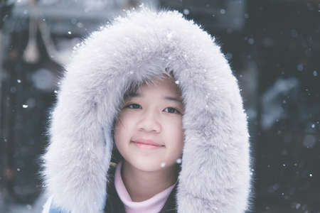 Beautiful Asian girl in the snowの写真素材