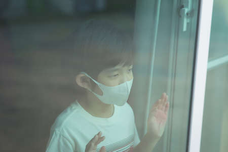Cute children boy and girl in medical mask stay at home in quarantineの写真素材