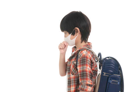 Asian student cough and waer hygienic mask on white background isolatedの写真素材