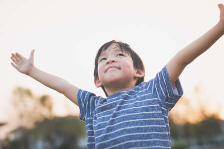 Cute Asian child playing pilot aviator in the park outdoorsの写真素材