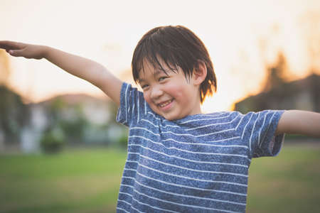 Cute Asian child playing pilot aviator in the park outdoorsの写真素材