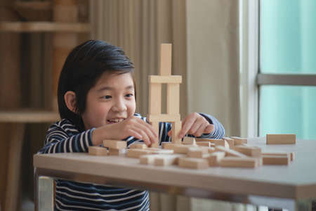 Cute asian child playing wooden blockの写真素材