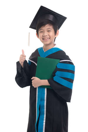 Asian boy student wearing graduation gown with ploma showing thumb on white background isolatedの写真素材