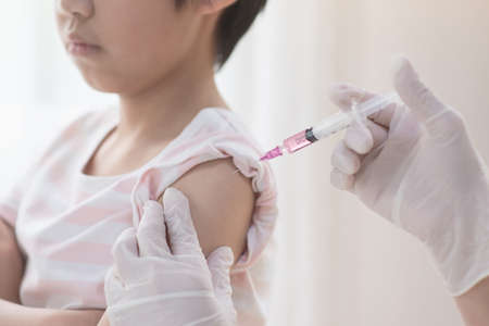 Asian child receiving injection or vaccine.の写真素材