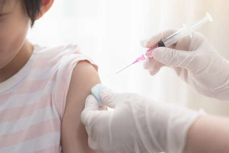 Asian child receiving injection or vaccine.の写真素材