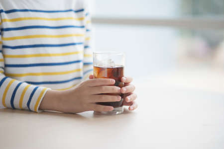 Little asian boy drinking soft drinkの写真素材