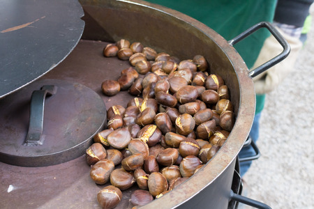 Organic Brown Chestnuts Roasting over a hot fire in winterの写真素材