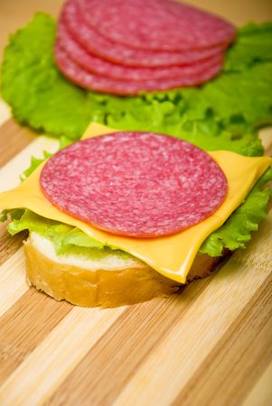  sandwich with sausage on a wooden boardの写真素材