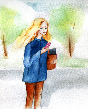 Blonde girl stands on spring street with the phone and waits. Waの写真素材