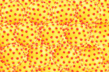 Abstract background of yellow balls with red bumps 