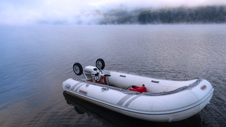 Sunrise on Lake Arvo with fog and a dinghyの写真素材