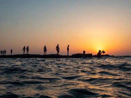 island of currents, silhouette of people at sunset 643