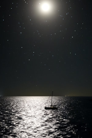Sailing yacht in the sea at night with starry sky.の写真素材