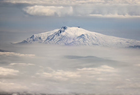 View of Mount Etna from the sea of clouds, Sicily, Italyの写真素材