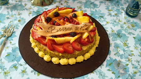 Birthday cake decorated with fruits and berries. Close-up.