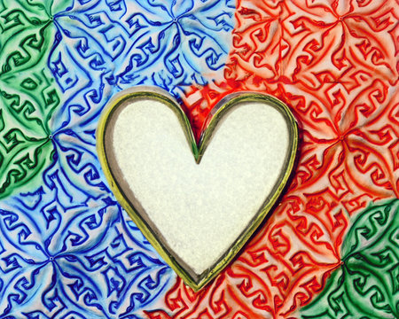 Colorful ceramic heart shape with blue red green and white background.