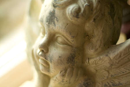 Angel stone statue holding his headの写真素材