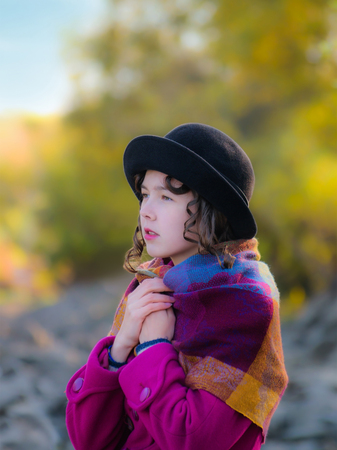 Girl freezing in the cool autumn day outdoors.の写真素材