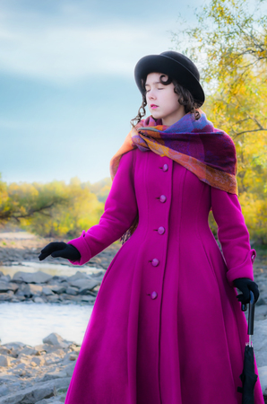 Girl goes to touch with his eyes closed, blindly, along the river bank.の写真素材