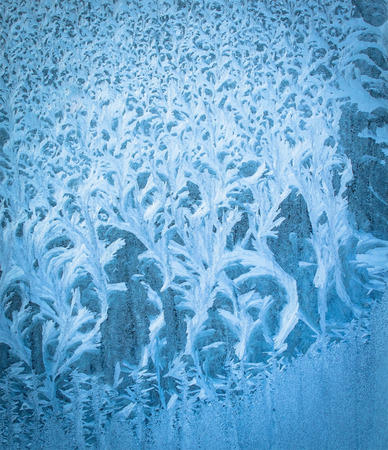 Frosty natural pattern on winter windowの写真素材