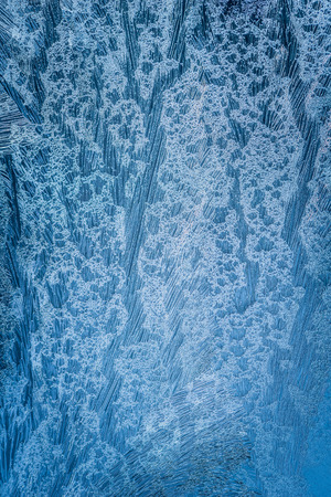 Frosty natural pattern on winter windowの写真素材
