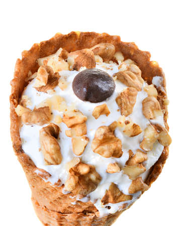 Ice cream in waffle cone with walnut isolated on white background.の写真素材