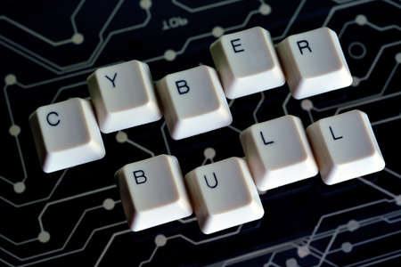 Keyboard keys form the word CYBER BULL on black electric circuit in the backgroundの写真素材